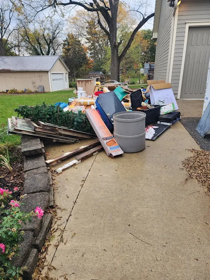 Dumpster being loaded with debris for 12 Yard Dumpster Rental in Sevierville